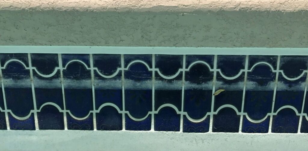 Tile line calcium removal before